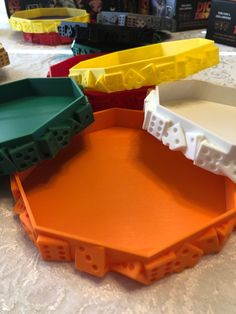 three plastic trays sitting on top of a table next to boxes with legos in them