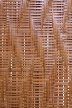 a close up view of a wall made out of woven bamboo sticks and wood strips