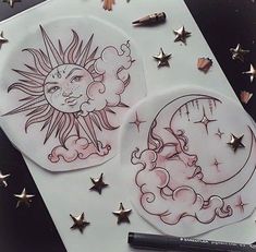 an image of two stickers with stars and the sun on them, next to a pen