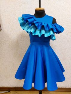 Gorgeous royal blue satin interview cocktail dress with light and royal blue  ruffles. Belt with two buttons back. Zipper side. Color: royal  and baby blue. Can  be made special for your little girl in any  size and  color. Blue Ruffled Dresses For Formal Occasions, Formal Blue Ruffled Dress, Fitted Sleeveless Pageant Dress With Ruffles, Royal Blue Fitted Dress For Pageant, Elegant Blue Pageant Dress For Party, Fitted Light Blue Pageant Dress For Party, Fitted Blue Ruffle Dress For Party, Blue Fitted Ruffle Dress For Party, Blue Sleeveless Ruffle Dress For Party