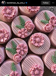 some pink chocolates with flowers and leaves on them