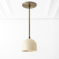 a light fixture hanging from the ceiling in a room with white walls and wood flooring