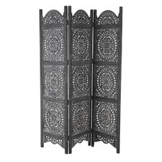 an ornate black screen with intricate carvings on the top and bottom, set against a white background