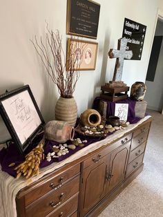 a table topped with vases filled with different types of plants and rocks on top of a purple blanket