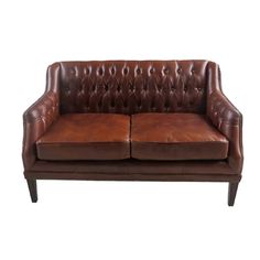 a brown leather couch sitting on top of a wooden frame