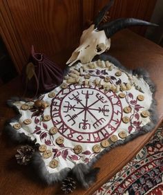 an animal skull is sitting on top of a table next to a clock and other items