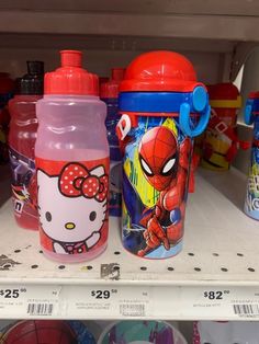 two hello kitty water bottles are sitting on the shelf next to each other in a store