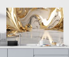 a kitchen with gold and white decor on the counter top next to a coffee maker