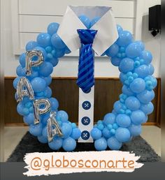 a blue balloon wreath with the words papa on it and balloons in the shape of letters