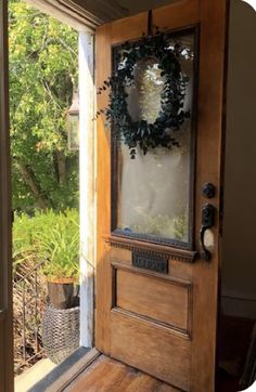 a wooden door with a wreath on the front and side glass paneled in to it