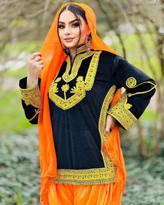 Kuchi Style Black Kurti with Split embroidered neckline, embroidered sleeves and full daman. Matched with orange balloon pants Afghani Shalwar with embroidery on hem, and matching orange dupatta. Simple Elegant Stylish Cute Afghan Kuchi 3 piece dress.  The dress is made in the best quality fabric. Kameez is made in black velvet fabric with chorma embroidery done on neckline, the borders of kameez and on both of the sleeves. Matching emboidery is done on the hem of Afghani orange shalwar which is Traditional Kaftan With Embroidered Sleeves For Eid, Traditional Long Sleeve Party Wear With Embroidered Border, Black Salwar Kameez For Traditional Ceremonies, Embroidered Long Sleeve Fabric With Dupatta For Traditional Ceremonies, Traditional Embroidered Tunic Set, Semi-stitched Salwar Kameez With Embroidered Long Sleeves, Ceremonial Embroidered Salwar Kameez, Bollywood Style Embroidered Semi-stitched Salwar Kameez, Long Sleeve Salwar Kameez With Embroidered Sleeves For Festivals