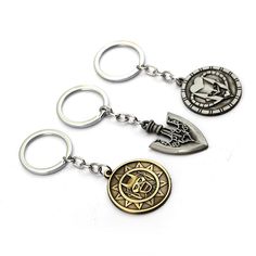 three metal key chains with different designs on them