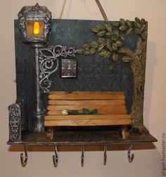 a wooden bench sitting under a light next to a lamp on a shelf with hooks