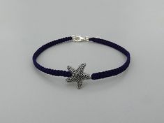 Embrace a holiday feeling every day with this UK made dainty 7" adjustable friendship bracelet for women.  It extends up to 8" so is ideal if you are buying this as a gift and do not know the exact wrist size of your recipient.  * Silver plated secure clasp and 1" extender chain.   * Zinc alloy sea star - lead, cadmium and nickel free. * Handmade in Cornwall using strong dark purple nylon cord.   ★ ALSO INCLUDED ★ Your bracelet will be wrapped in cream tissue paper inside a matching organza bag Adjustable Chain Bracelet With Star Charm As Gift, Adjustable Star Charm Chain Bracelet, Adjustable Braided Bracelet With Lobster Clasp, Handmade Star Charm Bracelet Adjustable, Silver Starfish Bracelet For Gift, Adjustable Sterling Silver Star Bracelet, Handmade Star-shaped Adjustable Charm Bracelet, Silver Starfish Bracelet, Adjustable Blue Jewelry With Starfish Charm