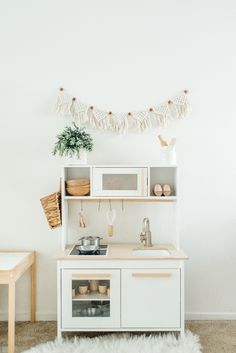 a kitchen with white walls and wooden furniture