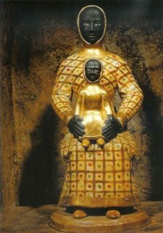 a gold statue with a black head and body