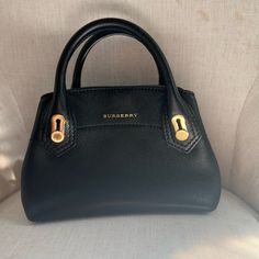 Burberry Small Black Milton- Authentic With All Tags/ Original Packaging/ Dust Bag/ Original Receipt. In Amazing Condition, Looks Brand New. Elegant Satchel With Branded Hardware For Everyday, Elegant Everyday Satchel With Branded Hardware, High-end Black Everyday Satchel, Black Luxury Tote Satchel For Everyday, Luxury Everyday Black Satchel With Top Carry Handle, Luxury Everyday Black Shoulder Bag With Handle Drop, Modern Black Satchel For Everyday Luxury, Modern Black Everyday Luxury Satchel, Modern Black Luxury Satchel