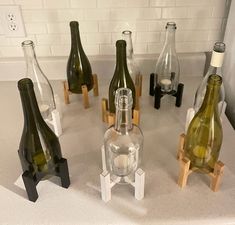 several wine bottles sitting on top of a counter next to each other in different shapes and sizes