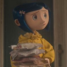 a doll with blue hair is holding some papers in her hands and looking at the camera