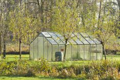 a small greenhouse in the middle of a field