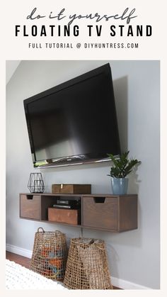 a flat screen tv mounted to the side of a wall next to baskets and a basket