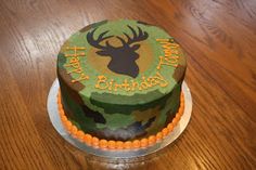 a camouflage birthday cake with an image of a deer on it