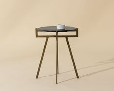 a small table with a cup on it