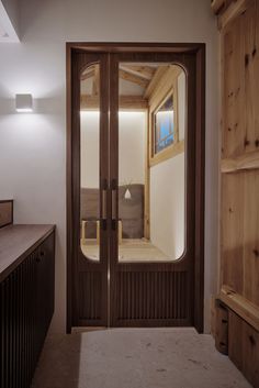 a large wooden door in a white room