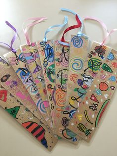 five gift tags with colorful designs on them