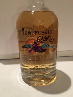 a bottle of daufuskie island rum sits on a countertop in front of a white wall