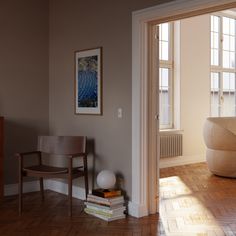 a living room with hard wood floors and white walls