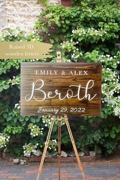 a wooden sign sitting on top of a easel