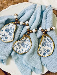 two blue and white dishes on a plate with some napkins hanging from the sides