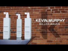 three bottles of kevin murphy killerwaves on a table in front of a brick wall