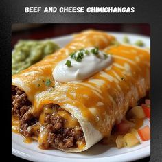 an enchilada with beef and cheese is on a plate