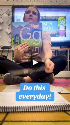 a woman sitting on the floor holding up a sign that says, go this everyday