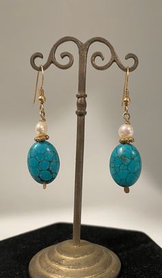 Handmade drop earrings with Turtleback Turquoise, White Freshwater Pearl, Indonesian Gold Vermeil spacer beads, and Gold-filled Ear wires. Natural Turquoise and Pearl, Turquoise is blue with black inclusions. Drop is 31.1mm. Turquoise Pearl Dangle Earrings, Handmade Turquoise Dangle Pearl Earrings, Portland Me, Buddha Pendant, White Freshwater Pearl, Natural Turquoise, Pendant Bracelet, Agate Beads, Fine Silver