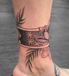 a woman's foot with a tattoo design on the top and bottom of it