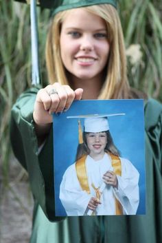 a young woman in graduation gown holding up a photo with a graduate cap and gown on