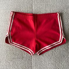 90s vintage red sporty shorts gymnastics workout shorts side stripe hot shorts summer basic. Model is 32D/26 waist/5ft. Measures 30 inches waist by 3 inches inseam. Faded tagged size, would best fit small-medium.