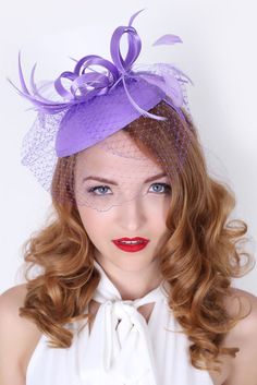 Be the envy of the party in this elegant felt fascinator. The round felt base is covered with satin ribbon loops, adorned with flighty feathers and topped off with a birdcage veil. This gorgeous piece is perfect for any special occasion. - Easy wear headband - Optional; tuck-a-way veil - Available in several other colors Lilac Fascinator, Lilac Hat, Felt Fascinator, Tea Party Attire, Purple Fascinator, Sinamay Hat, Wedding Birdcage, Sinamay Hats, Derby Dress