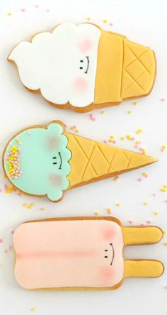 three ice cream shaped cookies sitting on top of a table