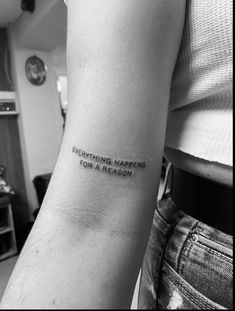 a person with a tattoo on their arm that says everything happens for a reason,