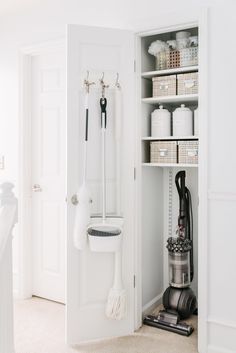 a white closet filled with lots of different types of cleaning supplies and accessories in it