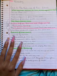 a woman's hand on top of a notebook with writing in it and the words workbook