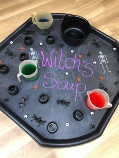 a witch's soup tray with cups and saucers on it