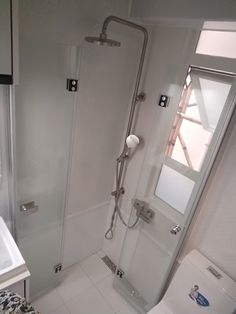 a bathroom with a shower, sink and toilet