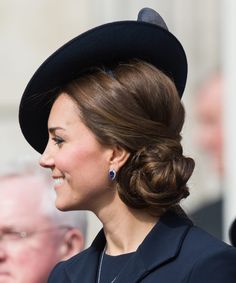 a woman wearing a black hat and dress