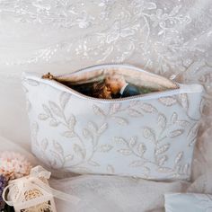 a bride and groom kiss in their wedding day pouch