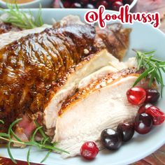 a plate with meat and cherries on it